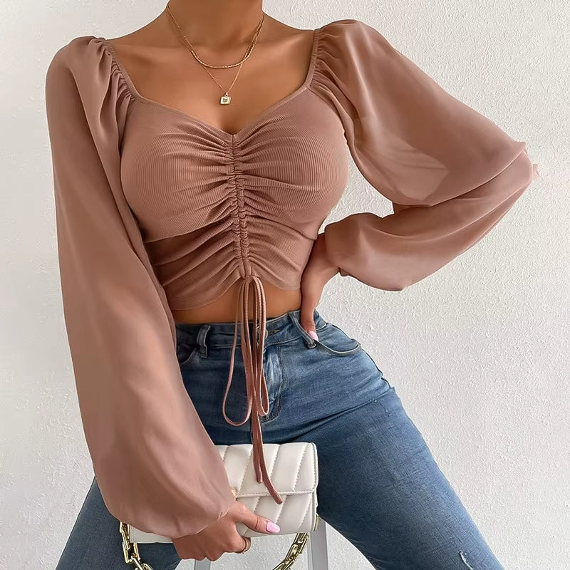Blusa corta con cinturón