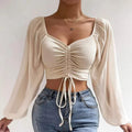 Blusa corta con cinturón