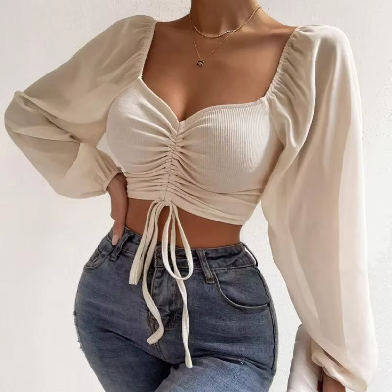 Blusa corta con cinturón